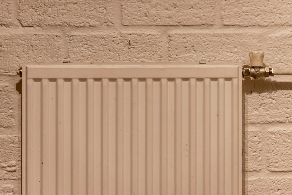 Modern white central heating radiator on a wall in an Ayr home