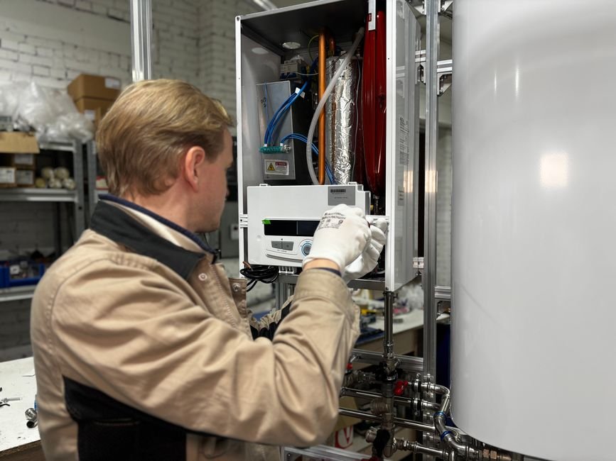 Heating engineer repairing a boiler and central heating system for a Clydebank customer