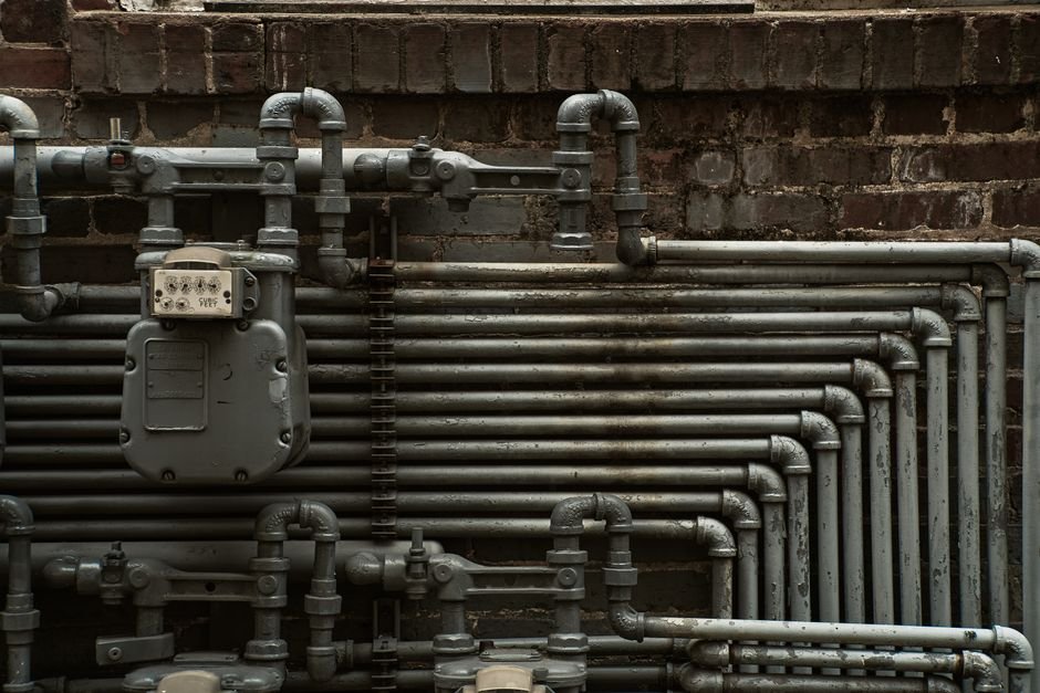 Close-up of steel pipework and a gas meter on a wall, the kind of gas and boiler work a Gas Safe engineer handles in Bishopbriggs