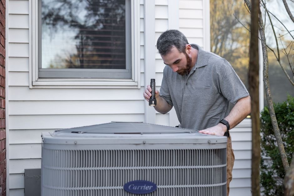 Heating engineer inspecting a boiler unit during a maintenance or breakdown callout