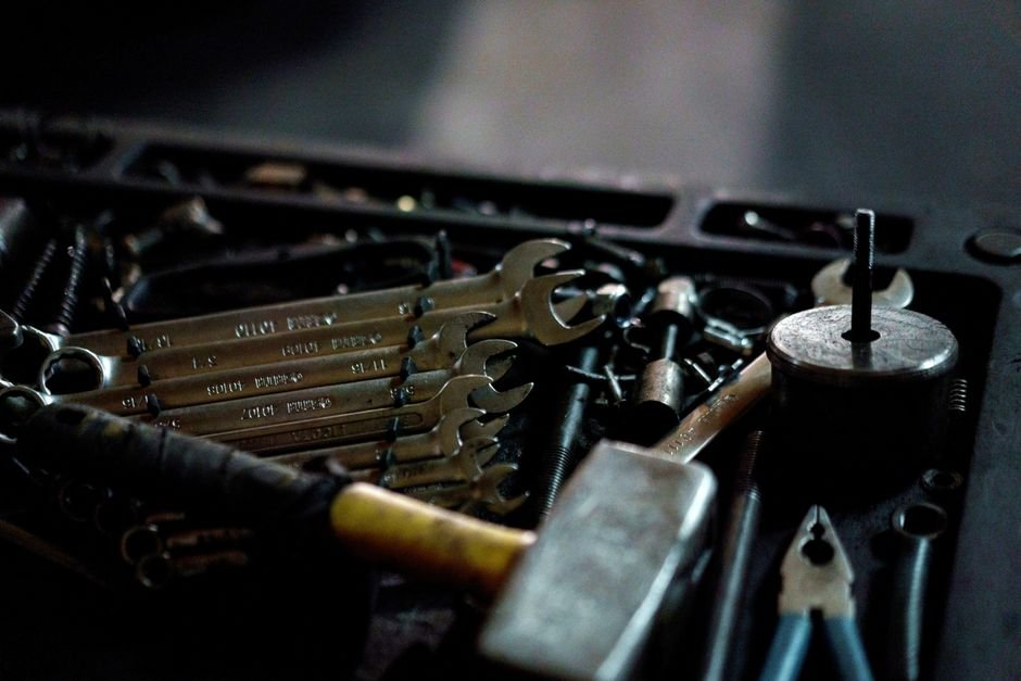 A tradesperson's toolbox of wrenches and hand tools, the kind of kit a Gas Safe engineer brings to a boiler installation job