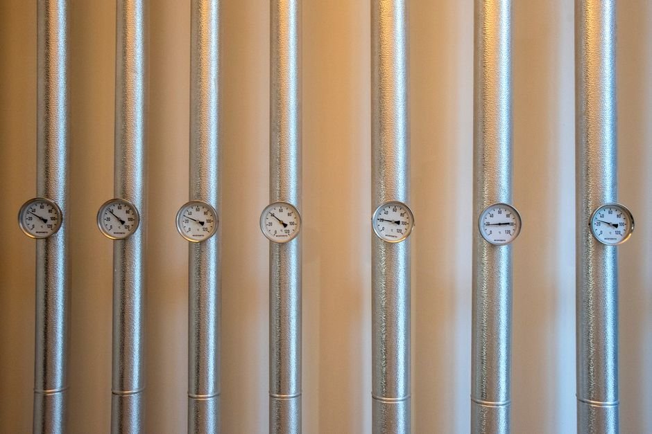 Close-up of pressure gauges on metal heating pipework, similar to what an engineer checks during a boiler repair visit