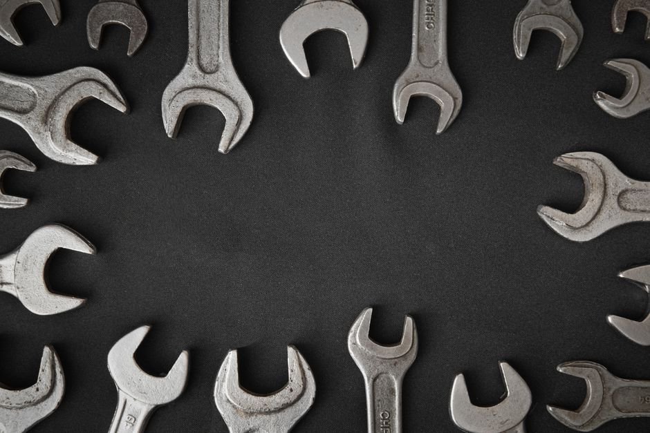 Assorted spanners and plumbing tools laid out, the kind a Dumbarton plumber carries for a boiler or pipework job