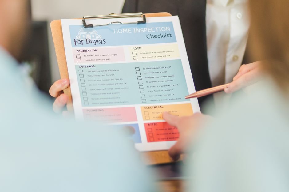 Close-up of hands holding a compliance checklist on a clipboard, representing the certificates a Scottish landlord must track and renew