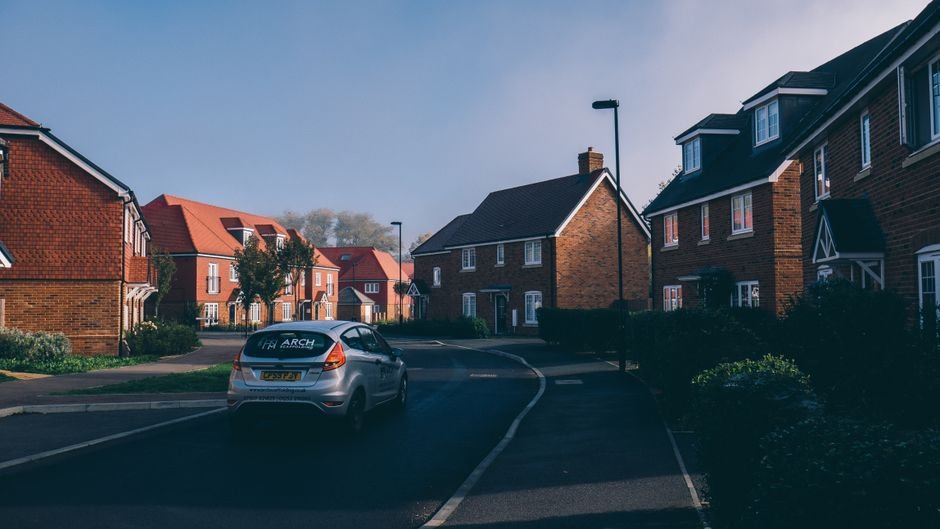 Quiet suburban street of brick detached and semi-detached houses, representative of the housing stock common across Bearsden