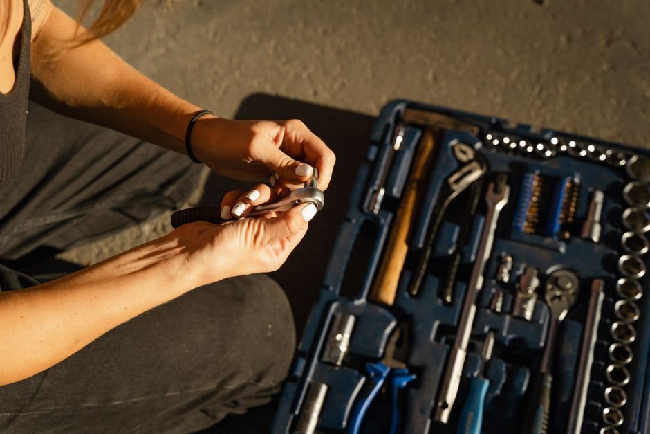Close-up of a tradesperson's hands using tools during a plumbing and heating repair job
