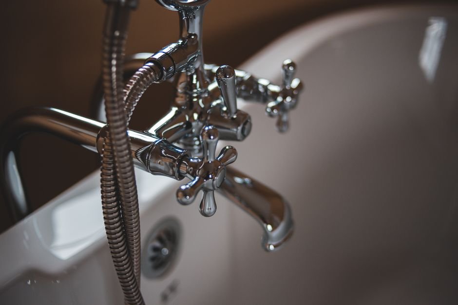 Close-up of a chrome bath and shower mixer tap on a roll-top style bath, the kind of original period bathroom fitting found in Pollokshields' Victorian villas
