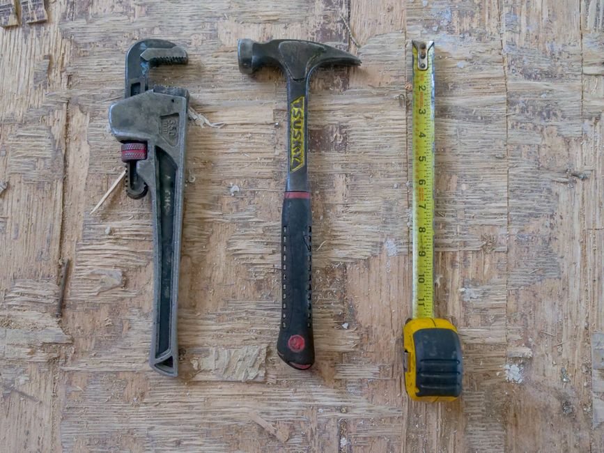 A set of metal wrenches laid out on a workbench, representative of the tools a Gas Safe registered plumber brings to a Shawlands call-out