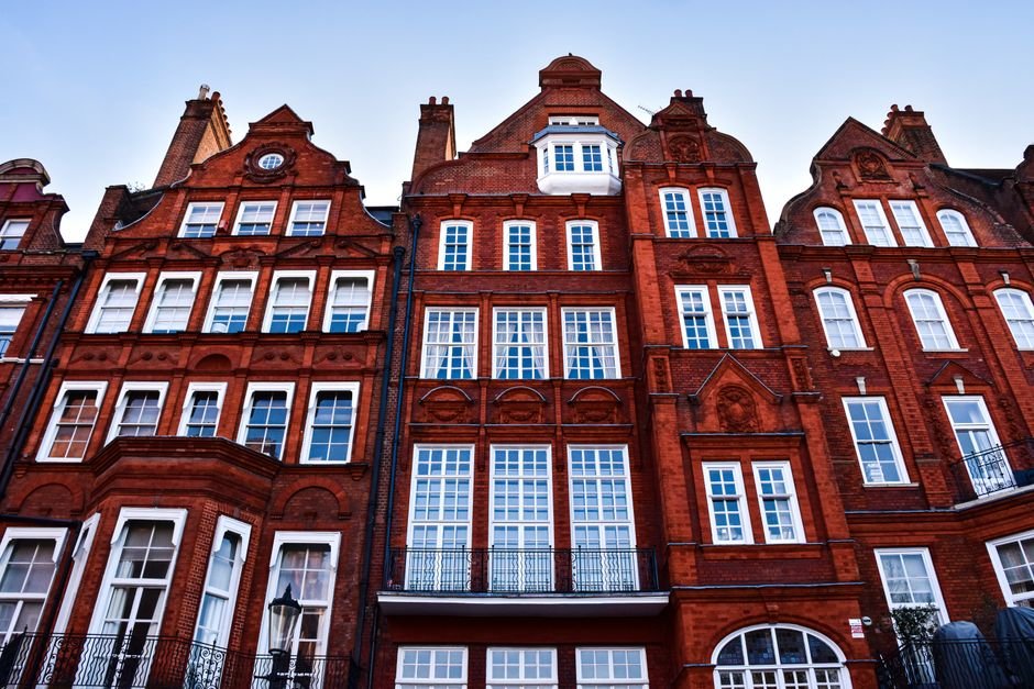 Sandstone and red-brick tenement buildings on a Glasgow street, typical of Shawlands and the wider Southside
